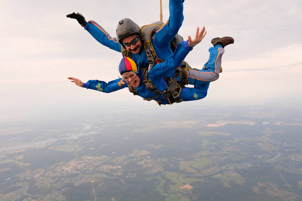 Skydiving. Tandem jump. A woman and her instructor are flying in the sky. - Photo, Image