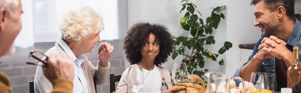 selective focus of joyful african american girl celebrating thanksgiving day with family, horizontal image - Foto, immagini