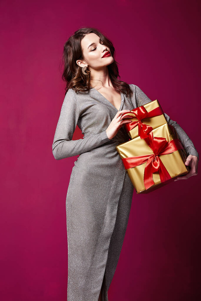 Beautiful young sexy woman thin slim figure evening makeup fashionable stylish dress clothing collection, brunette, gifts boxes red silk bows holiday party birthday New Year Christmas Valentine's Day. - Valokuva, kuva