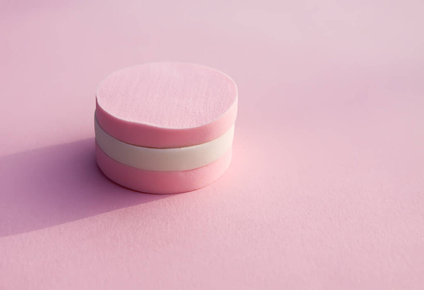 Cosmetic sponges in pastel colors on pink background. - Foto, Imagen