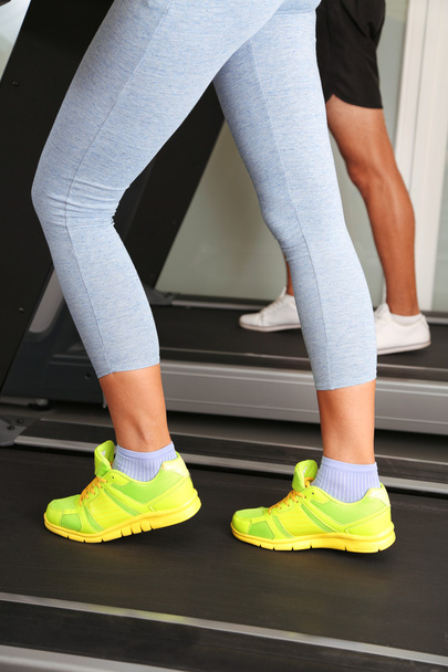 Women and men feet on treadmill close-up - Fotoğraf, Görsel