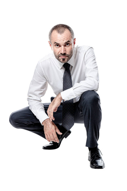 businessman crouching isolated on white. Caucasian with beard. - Zdjęcie, obraz