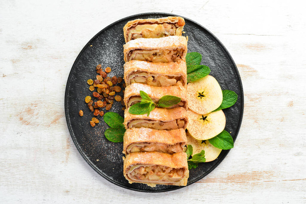 Sweet Strudel with apples and dried fruits. Top view, free copy space. - Foto, imagen