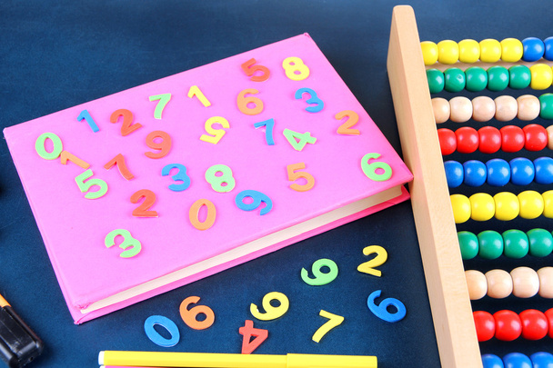 Colorful numbers, abacus, books and markers on school desk background - Fotoğraf, Görsel