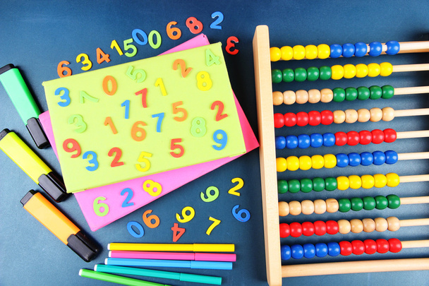 Colorful numbers, abacus, books and markers on school desk background - Fotoğraf, Görsel