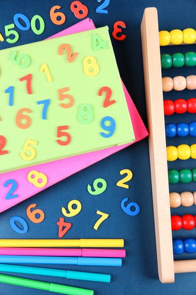 Colorful numbers, abacus, books and markers on school desk background - Foto, Imagem