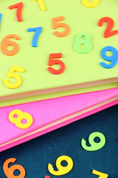 Colorful numbers and books on school desk background - Photo, image