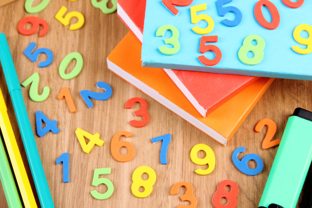 Colorful numbers, books and markers on wooden background - Foto, immagini