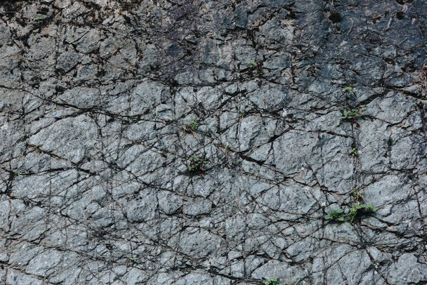 Dark rock texture with cracks - Фото, зображення
