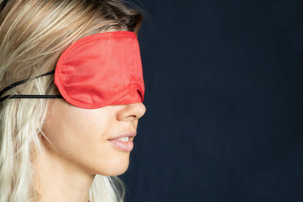 portrait of a girl with a red blindfold on an isolated background close up - Fotografie, Obrázek