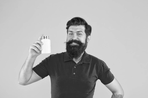 Healthy Happy Smiling Man Going To Prepare Protein Shake Drink. anabolic and steroids. brutal bearded hipster man hold vitamin. medicine pills and drugs. haircare. jar of vaccine - 写真・画像