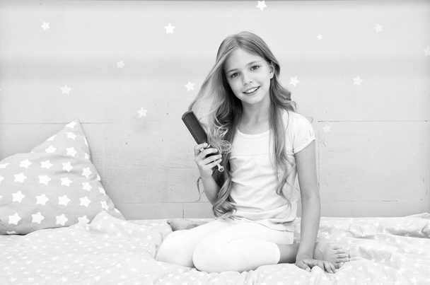 Relaxing hair brushing. Happy child hold hair brush. Brushing before and after bed. Haircare and styling. Untangling or brushing. Brushing hair stimulates its grows - 写真・画像
