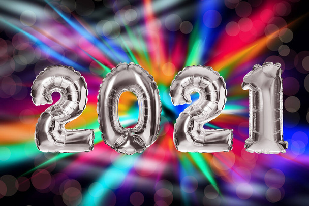 2021 New Year celebration. Creative design with bright balloons and blurred lights on color background - Foto, afbeelding