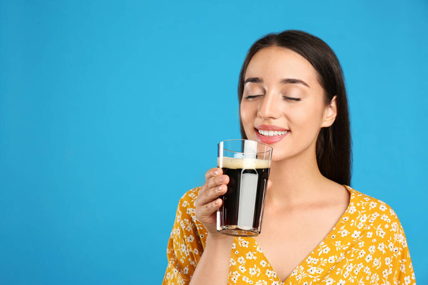 Beautiful woman with cold kvass on blue background. Traditional Russian summer drink - Foto, Imagem