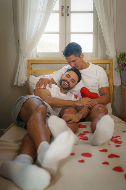 LGBT married caucasian gay couple having romantic moment together in bedroom - Foto, afbeelding