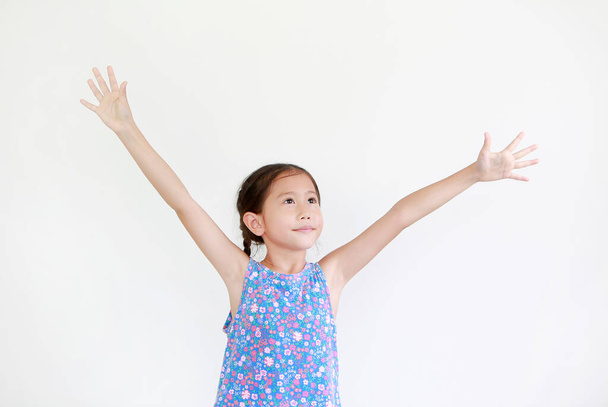 Asian little kid girl with pigtail hair standing and open wide arms with looking up isolated on white background. - Photo, Image
