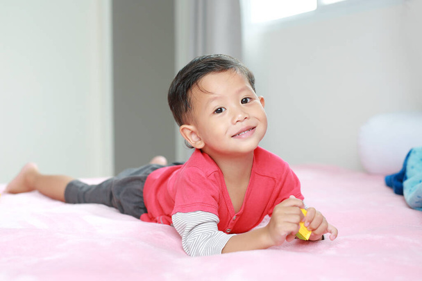 Portrait of cute asian little baby boy lying on the bed with looking camera. - Fotoğraf, Görsel