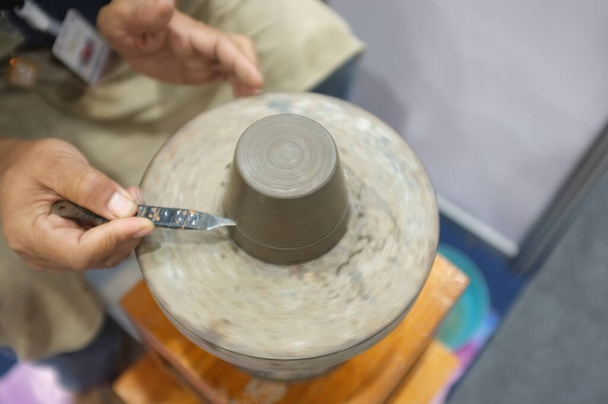 Concept Ceramic workshop. The man Throwing clay bowl on a pottery's wheel. - Photo, Image