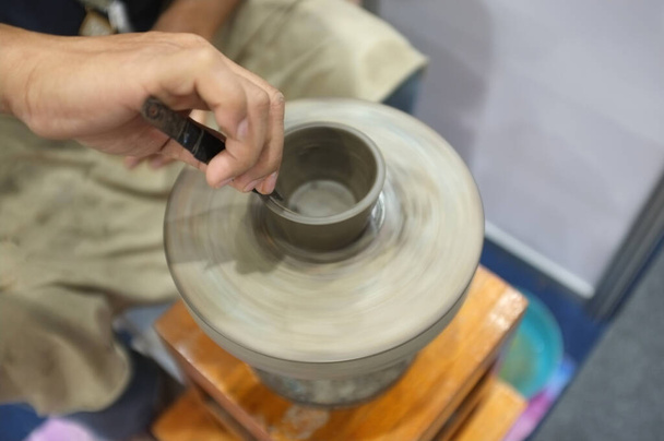 Concept Ceramic workshop. The man Throwing clay bowl on a pottery's wheel. - Photo, Image