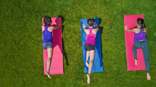 Family fitness and sport outdoors, group of active girls doing workout in park, aerial top view from above - Valokuva, kuva