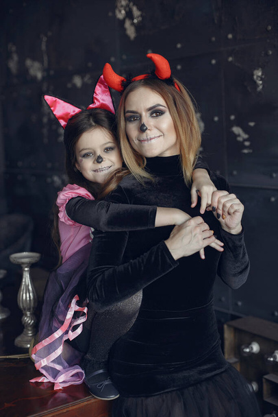 Mother with daughter in a halloween costume and makeup - Fotografie, Obrázek