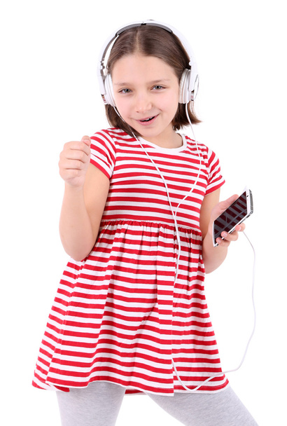 Beautiful little girl listening to music, isolated on white - Foto, imagen