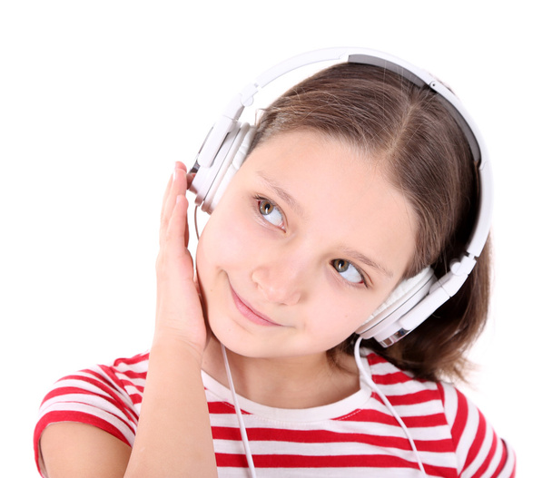 Beautiful little girl listening to music, isolated on white - 写真・画像