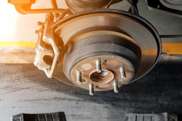 modern car disc brake to be fixed at garage or automotive service station with sunlight effect - Valokuva, kuva