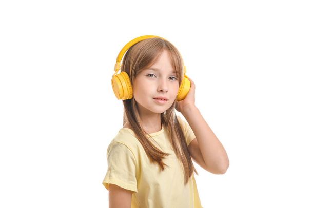 Little girl listening to music on white background - Photo, Image