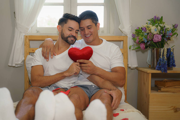 LGBT married caucasian gay couple having romantic moment together in bedroom - Фото, зображення