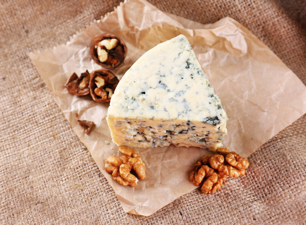 Tasty blue cheese with nuts, on burlap background - Photo, Image