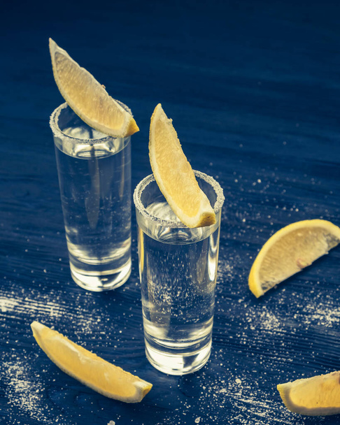 Tequila.  Alcohol in shot glasses, lemon and salt. Closeup. Toned photo - Fotografie, Obrázek