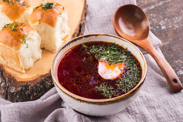 Traditional russian red hot borsch beetroot soup with sour cream and buns. - Photo, Image