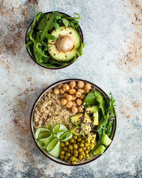 Healthy vegetable lunch from the Buddha bowl with quinoa, avocado, chickpeas, cucumber. The concept of a healthy food dish for vegetarians, a trend dish. High quality photo - Photo, Image