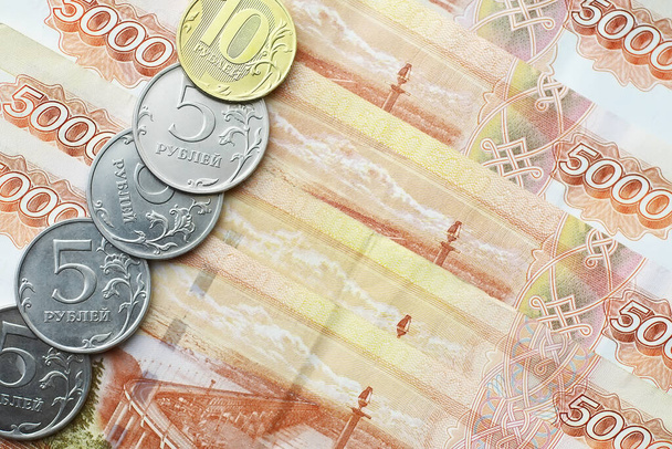 Orosz bankjegyek és érmék "rubel". 5 és 10 rubeles bankjegy "ötezer rubel" felirattal és érmékkel. Pénzbeli háttér. - Fotó, kép