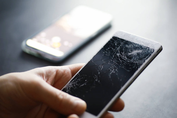 Smartphone with a broken touch screen. Mobile phone broken. The phone crashed. Replacing broken glass on a cell phone. Smartphone repair. - Photo, Image
