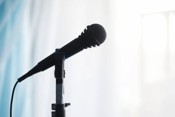 Stand with a microphone. Man holds hands a microphone on tripod. Performance of the artist with a microphone. Scene with a microphone. - Photo, Image