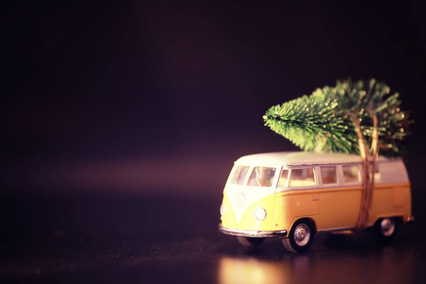 Christmas tree on toy car. Toy car Christmas tree. Christmas holiday celebration concept - Photo, Image