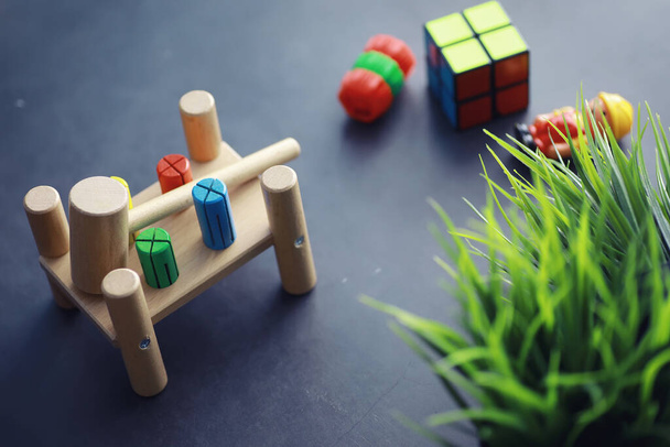 Children's development. Children's wooden toy on table in the play area. Room of children's creativity and self-development. Wooden constructor. - Photo, Image
