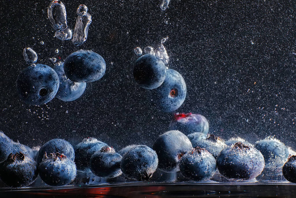 Water drops on ripe sweet blueberry. Fresh blueberries background with copy space for your text. Vegan and vegetarian concept. Macro texture of blueberry berries. - Photo, Image