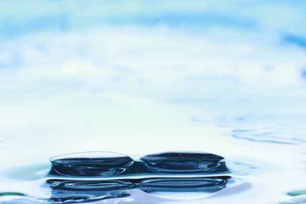 Tools for vision correction. Glasses and lenses with diopters on background of splashes and blurry. - Photo, Image