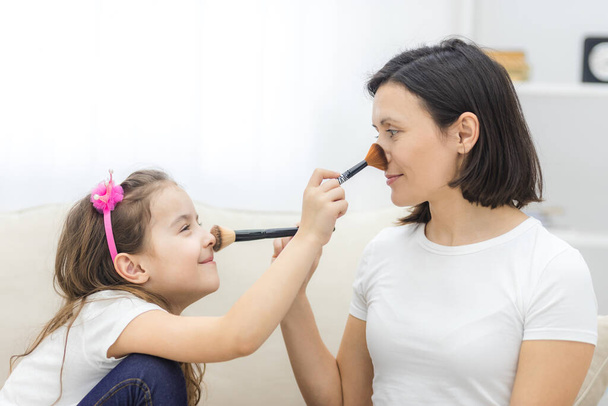 Photo of mother and daughter relationship, doing make up. - 写真・画像