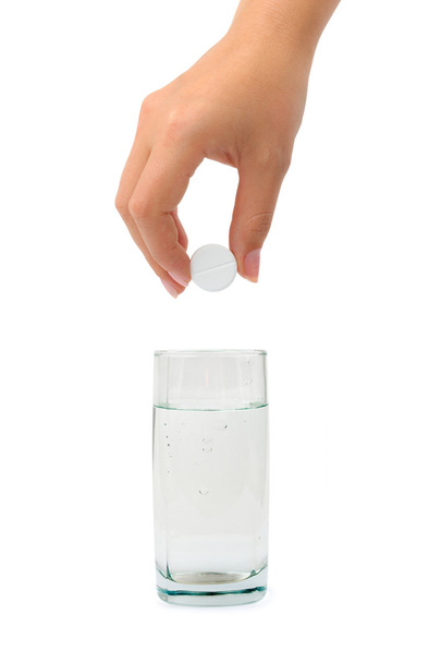 Hand with pill and water glass - Foto, afbeelding