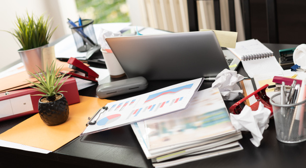Messy and cluttered office desk - Photo, Image