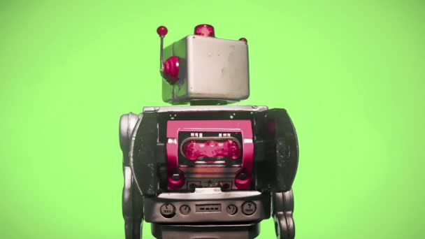 retro-robotti, jossa on pyörivä pää vasemmalla ja oikea silmukka vihreällä näytöllä - Materiaali, video