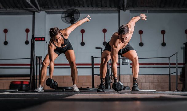 A closeup shot of an athletic male and female in the gym - Foto, imagen