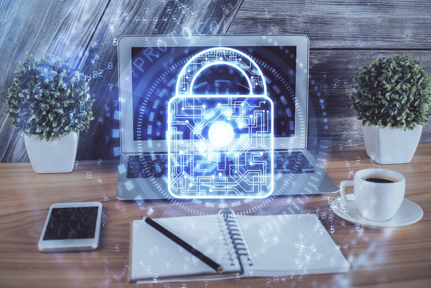 Double exposure of desktop with computer and lock icon hologram. Concept of data safety. - Photo, image