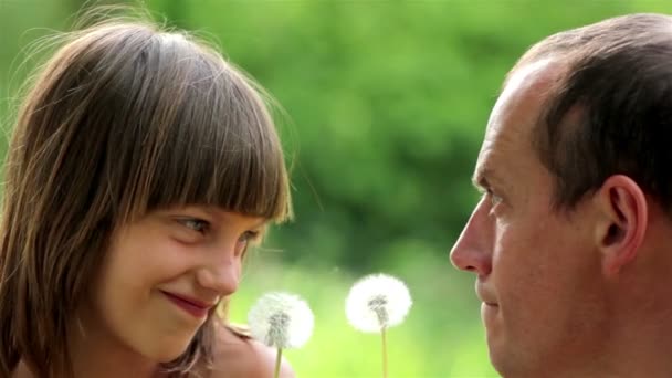 Happy father and son blowing dandelion seeds - Footage, Video