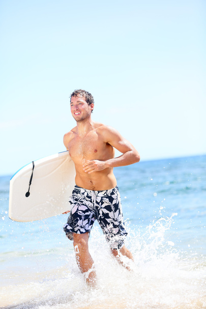 Summer beach fun surfer man running with bodyboard - Фото, изображение