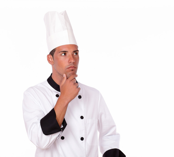 Pensive hispanic chef looking at people - Foto, immagini